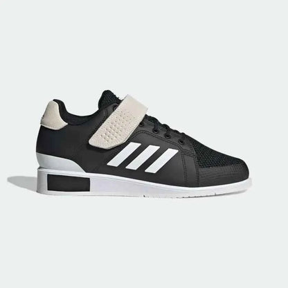 Black athletic sneaker with white stripes, beige strap, and white sole on plain background