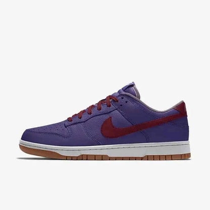 Purple and red Nike low-top sneaker with white midsole and gum sole on white background
