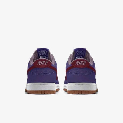 Back view of purple and red Nike sneakers with gum soles on a white background
